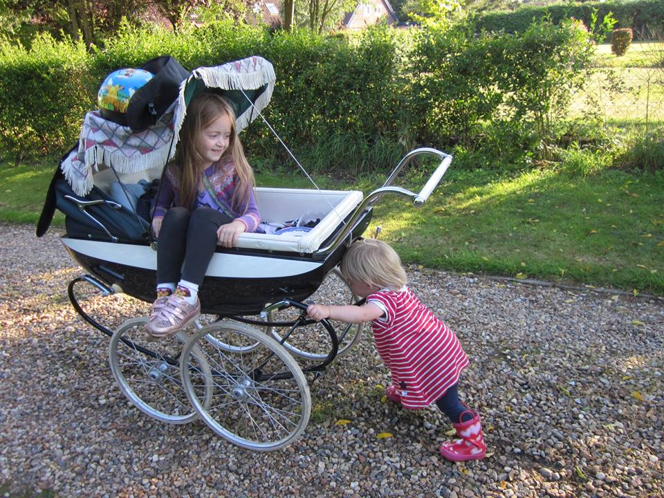 Siblings Playing With Pushchair
